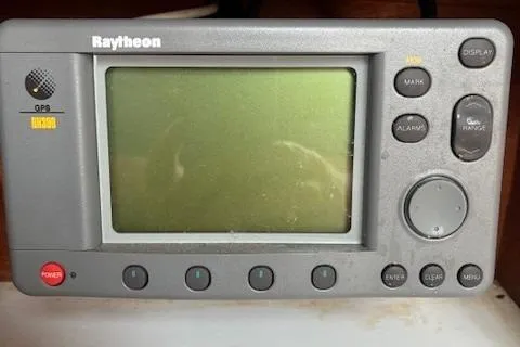 Slide: The Image of Raytheon GPS display on 1984 Catalina 38 sailboat, featuring multiple control buttons. - 27