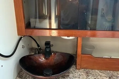 Slide: The Image of 1984 Catalina 38 yacht bathroom with modern sink and wooden cabinetry. - 6