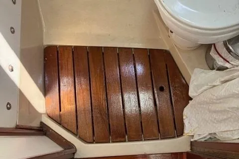 Slide: The Image of Wooden floor in 1984 Catalina 38 boat bathroom with white fixtures. - 7
