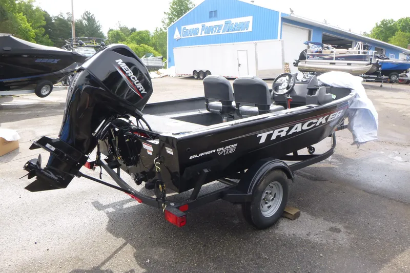 Slide: The Image of 2026 Tracker Super Guide V-16 SC boat with Mercury engine at marina. - 4