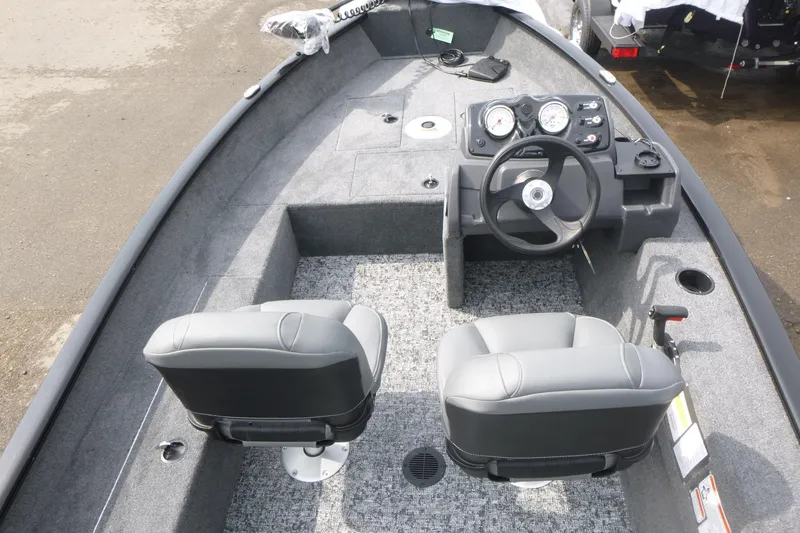 Slide: The Image of 2026 Tracker Super Guide V-16 SC boat interior with dual seats and steering console. - 5