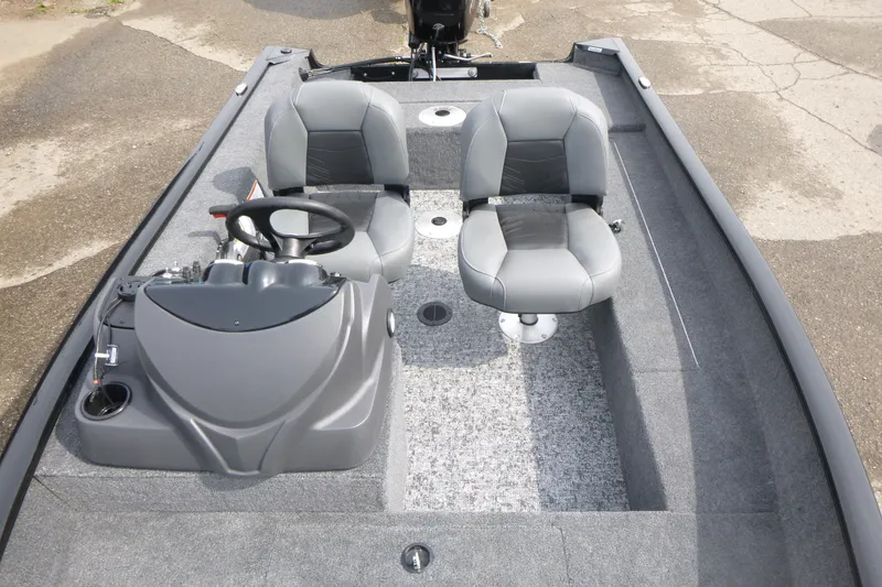 Slide: The Image of 2026 Tracker Super Guide V-16 SC boat interior with dual seats and steering console. - 6