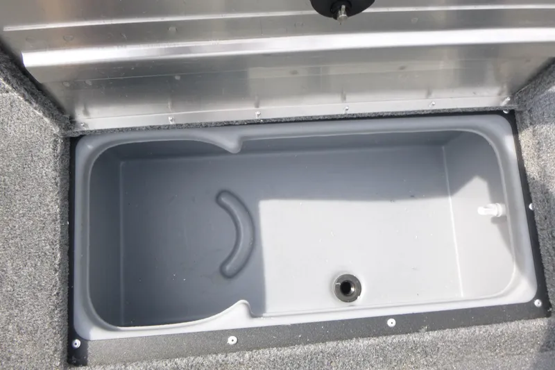 Slide: The Image of 2026 Tracker Super Guide V-16 SC boat storage compartment, open and empty. - 9