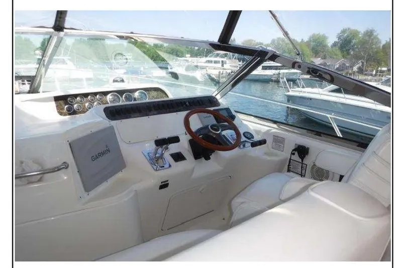 Slide: The Image of 1997 Sea Ray 400 Sundancer helm with Garmin navigation, docked at marina. - 5
