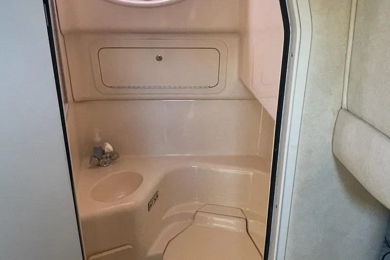 Slide: The Image of 1997 Sea Ray 400 Sundancer bathroom interior with sink and storage compartment. - 6