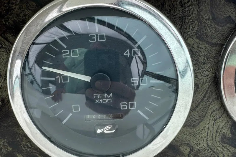 Slide: The Image of Tachometer of 1997 Sea Ray 400 Sundancer showing RPM with reflective surface. - 8