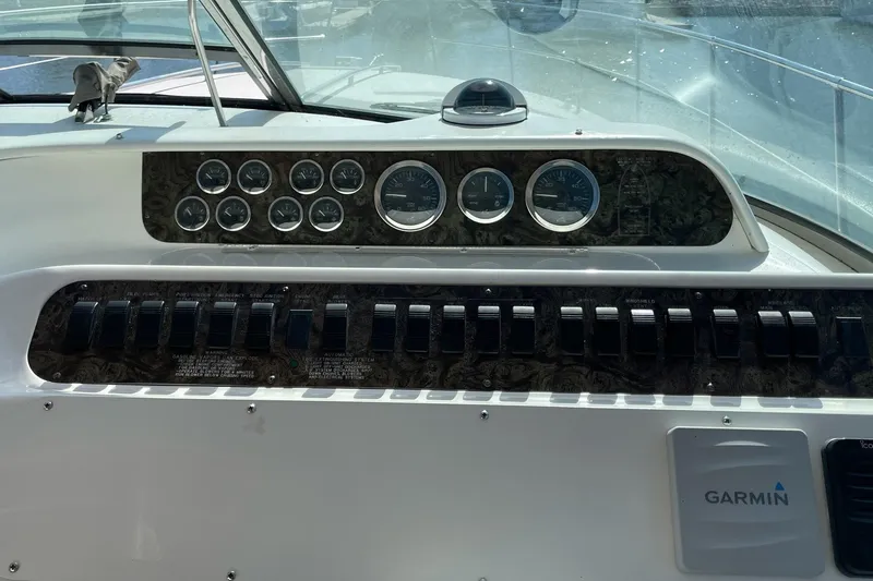Slide: The Image of Dashboard of a 1997 Sea Ray 400 Sundancer boat with gauges and Garmin device. - 9