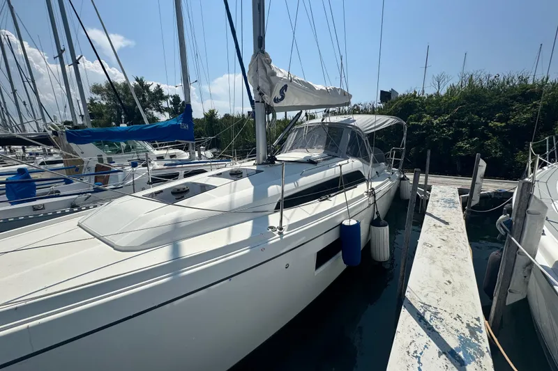 Slide: The Image of 2020 Beneteau Oceanis 30.1 sailboat docked at marina under clear sky. - 1