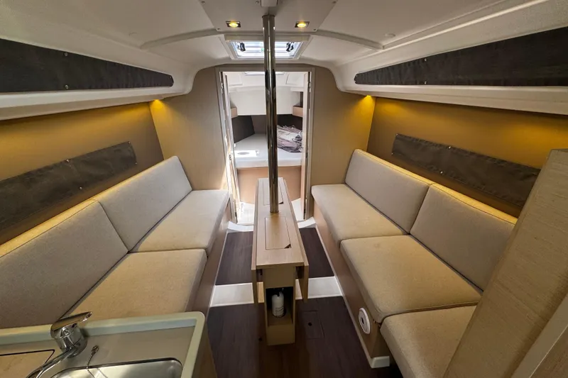 Slide: The Image of Interior of 2020 Beneteau Oceanis 30.1 yacht, featuring cozy seating and modern design. - 12