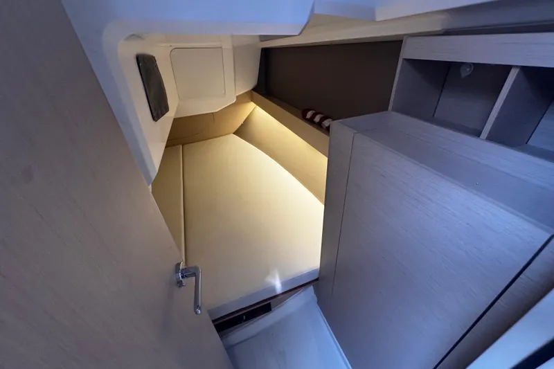 Slide: The Image of Cozy cabin interior of 2020 Beneteau Oceanis 30.1 sailboat, featuring modern wood finish. - 13