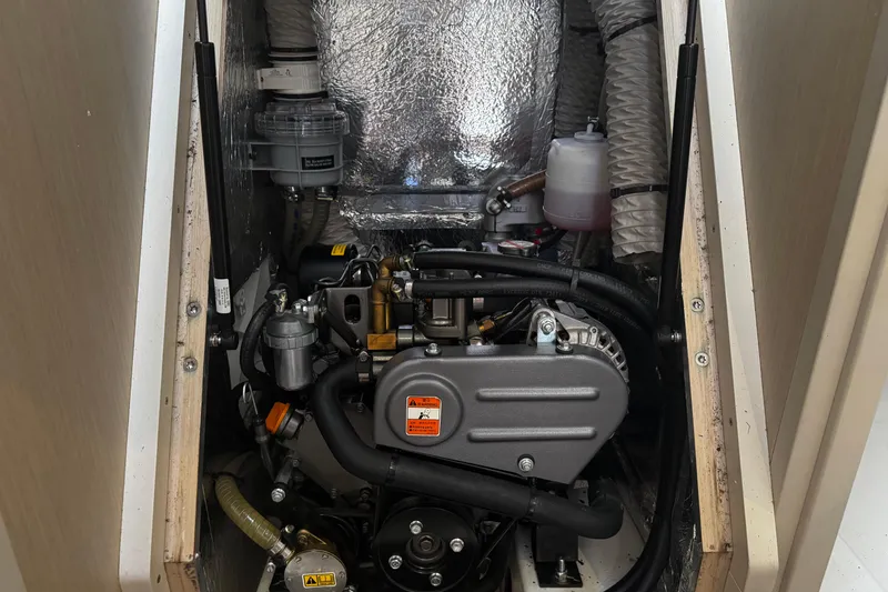 Slide: The Image of Engine compartment of a 2020 Beneteau Oceanis 30.1 sailboat, showcasing mechanical components. - 19