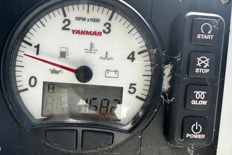Slide: The Image of Yanmar tachometer on 2020 Beneteau Oceanis 30.1 sailboat dashboard, showing RPM and control buttons. - 21