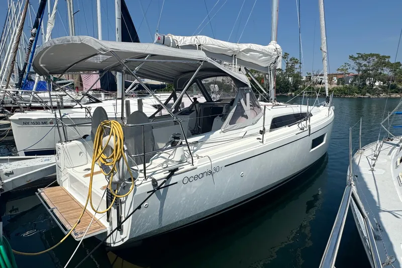Slide: The Image of 2020 Beneteau Oceanis 30.1 sailboat docked at marina, side view. - 3