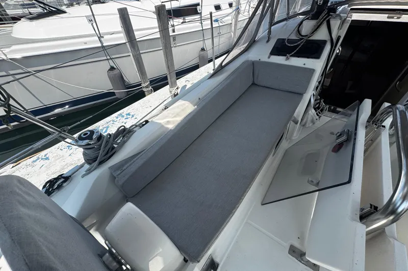 Slide: The Image of 2020 Beneteau Oceanis 30.1 sailboat cockpit with gray cushions and open hatch. - 4