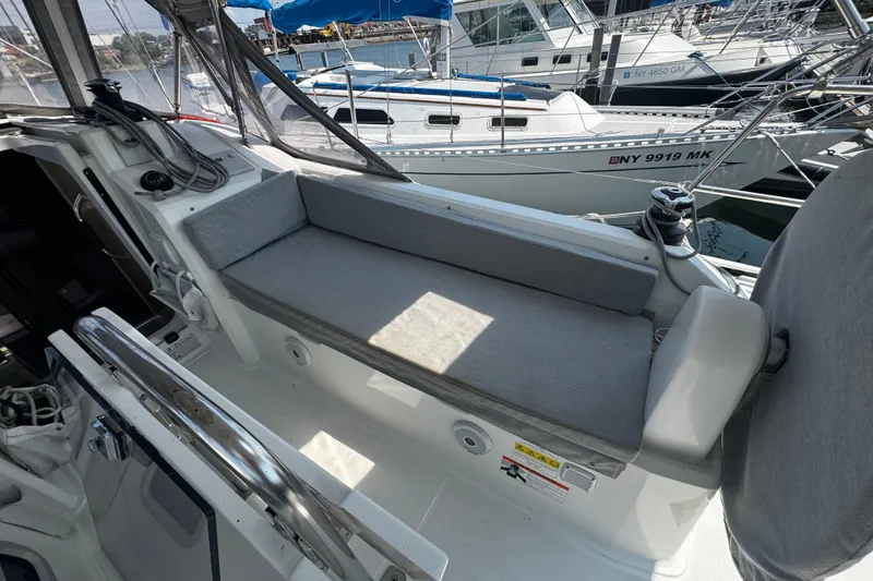 Slide: The Image of Beneteau Oceanis 30.1 cockpit with cushioned seating, docked at marina, 2020 model. - 5