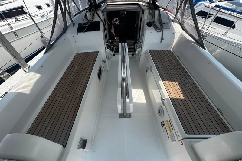 Slide: The Image of 2020 Beneteau Oceanis 30.1 yacht cockpit with wooden seating and sleek design. - 7