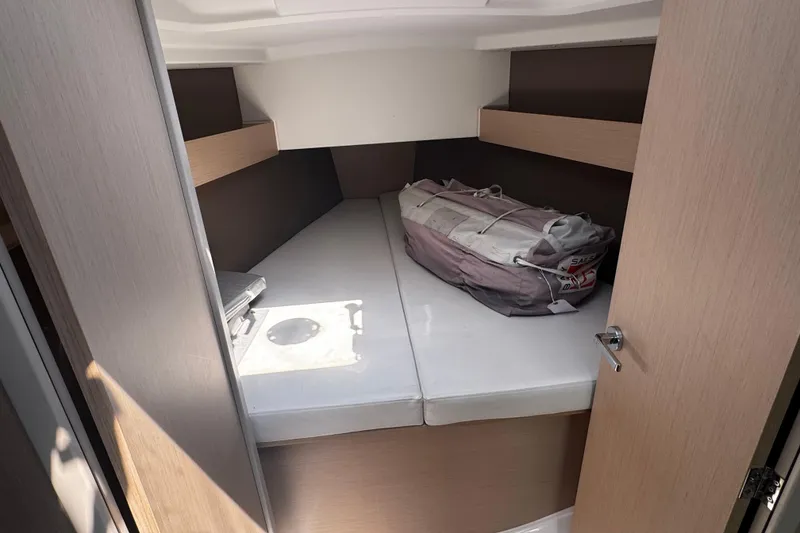 Slide: The Image of Interior cabin of 2020 Beneteau Oceanis 30.1 sailboat, featuring a cozy sleeping area. - 9