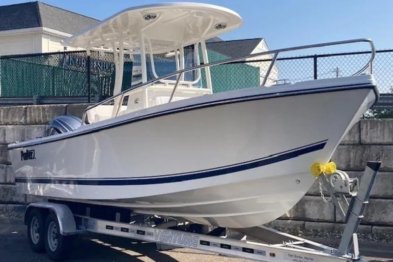 The Image of 2025 Parker 23 SE CC boat on trailer, white hull, outdoor setting. - 1