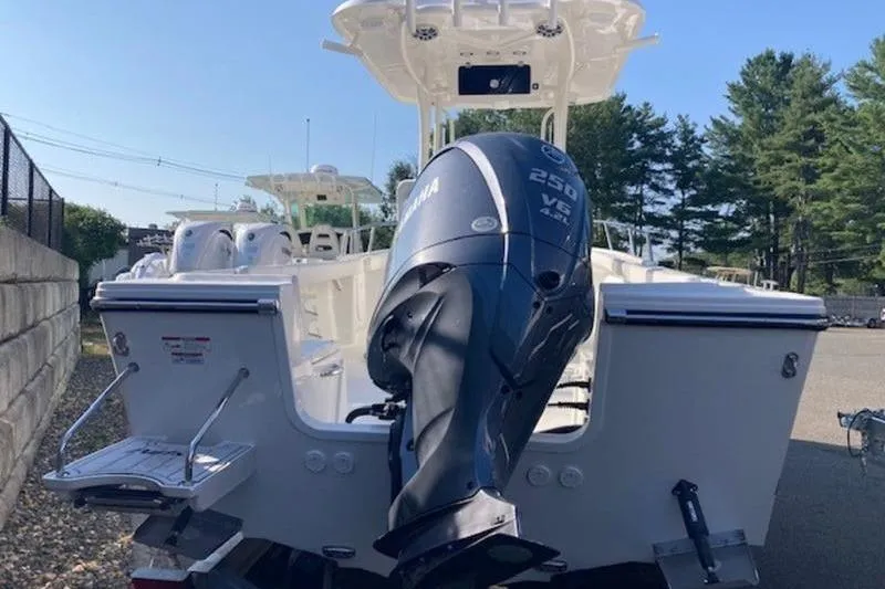 Slide: The Image of 2025 Parker 23 SE CC boat with Yamaha 250 V6 engine, docked outdoors. - 10