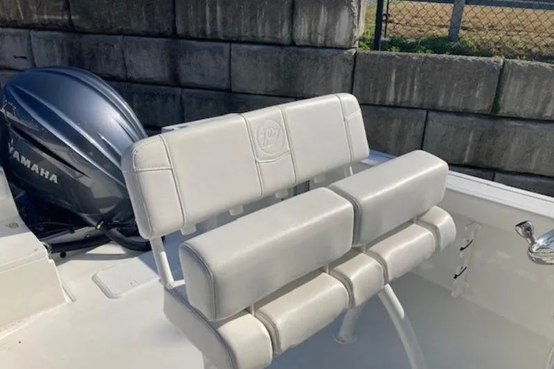Slide: The Image of 2025 Parker 23 SE CC boat with Yamaha engine and white seating. - 4