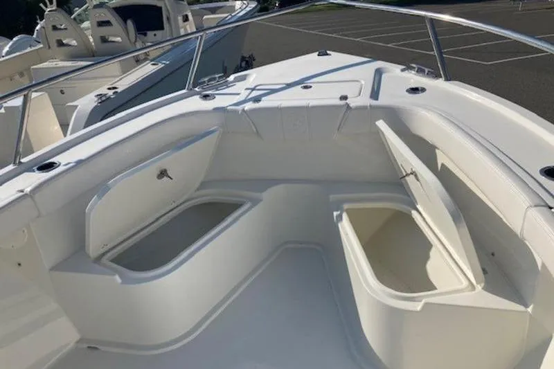 Slide: The Image of 2025 Parker 23 SE CC boat interior with open storage compartments. - 6