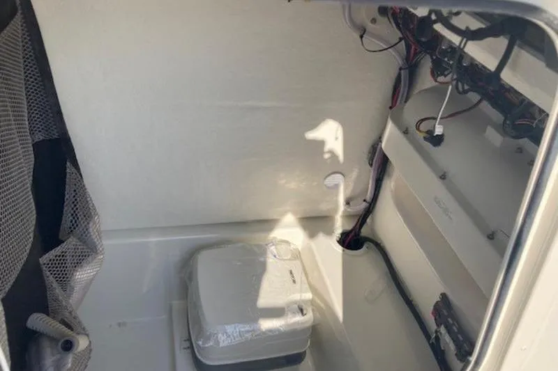 Slide: The Image of Interior of 2025 Parker 23 SE CC boat with wiring and portable toilet. - 8