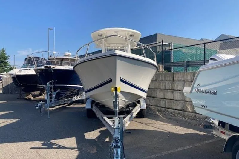 Slide: The Image of 2025 Parker 23 SE CC boat on trailer in a marina lot. - 9