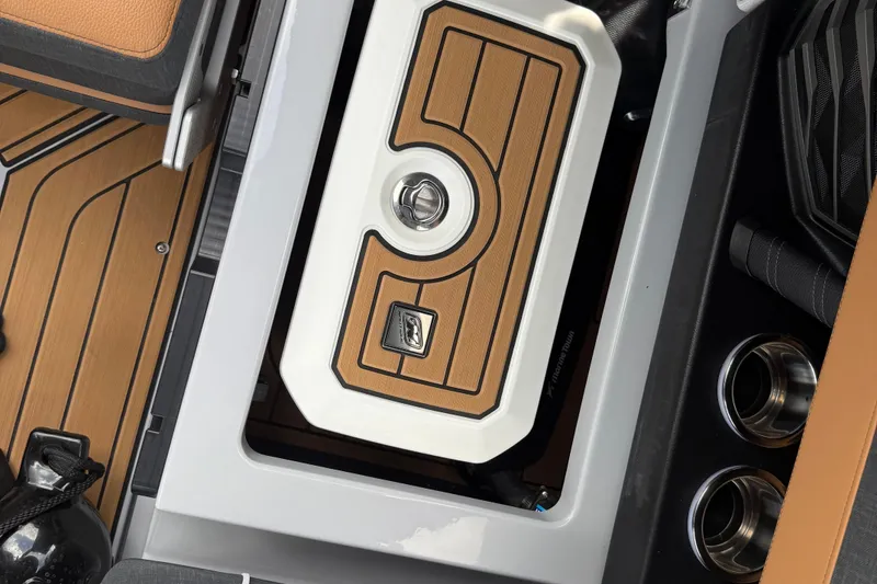 Slide: The Image of 2024 Nautique Super Air Nautique G21 interior with teak-style flooring and storage compartment. - 10