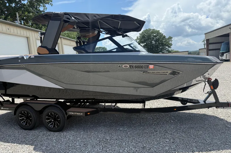 Slide: The Image of 2024 Nautique Super Air Nautique G21 boat on trailer, parked outdoors. - 3