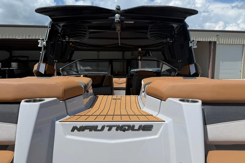 Slide: The Image of 2024 Nautique Super Air Nautique G21 boat interior with tan seating and sleek design. - 4