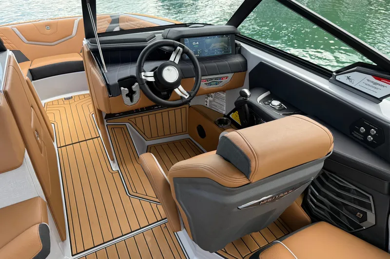 Slide: The Image of 2024 Nautique Super Air Nautique G21 interior with tan upholstery and modern dashboard. - 6
