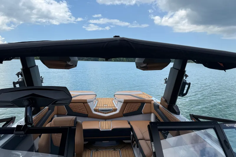 Slide: The Image of 2024 Nautique Super Air Nautique G21 interior with lake view, featuring luxurious seating and modern design. - 9
