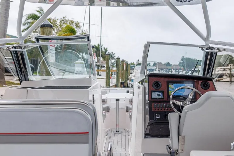 Slide: The Image of Manufacturer Provided Image: Cockpit view of 2025 Solara S-250 DC boat with modern dashboard and steering. - 4