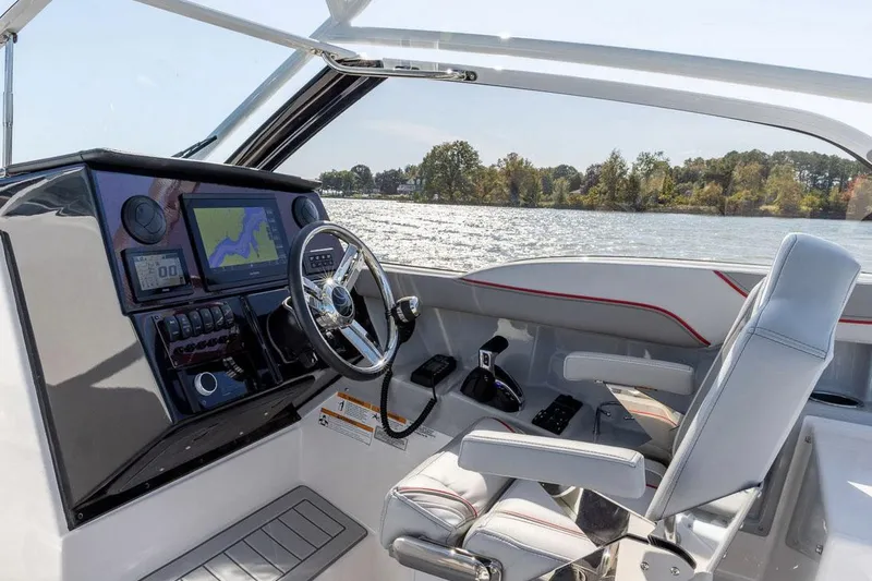 Slide: The Image of Manufacturer Provided Image: 2025 Solara S-250 DC boat interior with modern dashboard and steering wheel on a sunny day. - 5