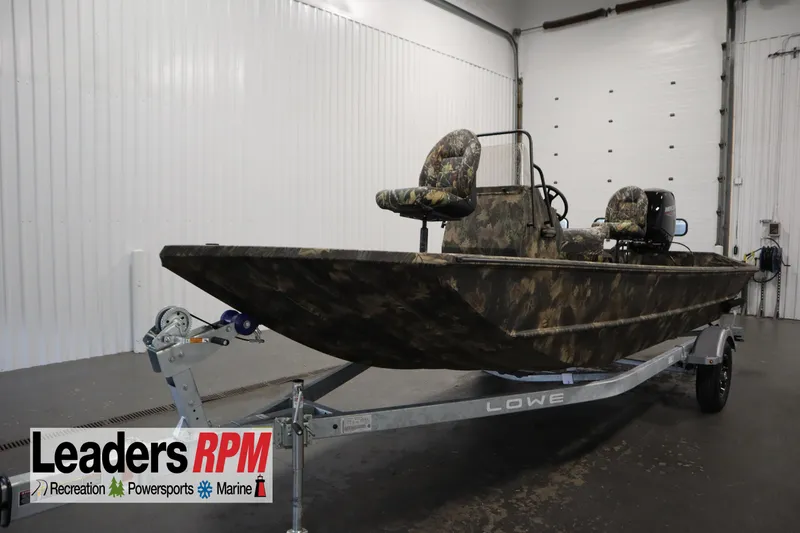 The Image of 2026 Lowe Roughneck RX2070 CC boat with camouflage design on trailer in showroom. - 0