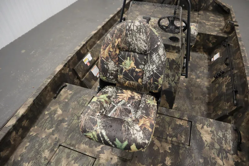 Slide: The Image of 2026 Lowe Roughneck RX2070 CC boat interior with camo seats and steering console. - 13