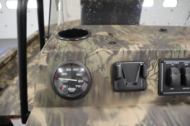 Slide: The Image of 2026 Lowe Roughneck RX2070 CC dashboard with camo design, RPM gauge, and control switches. - 17