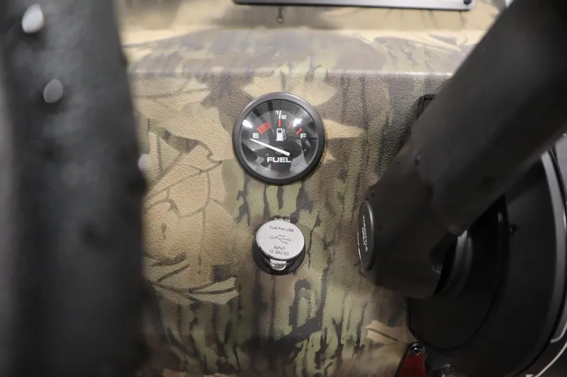Slide: The Image of Fuel gauge and USB port on 2026 Lowe Roughneck RX2070 CC boat dashboard. - 19