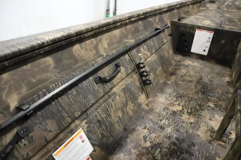 Slide: The Image of 2026 Lowe Roughneck RX2070 CC interior with camouflage design and safety instructions. - 22