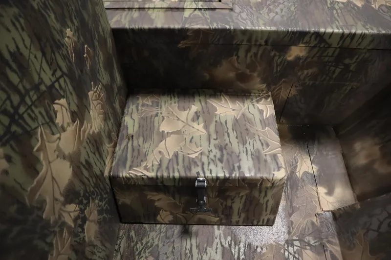 Slide: The Image of Camouflage interior of 2026 Lowe Roughneck RX2070 CC boat, featuring a storage compartment. - 23