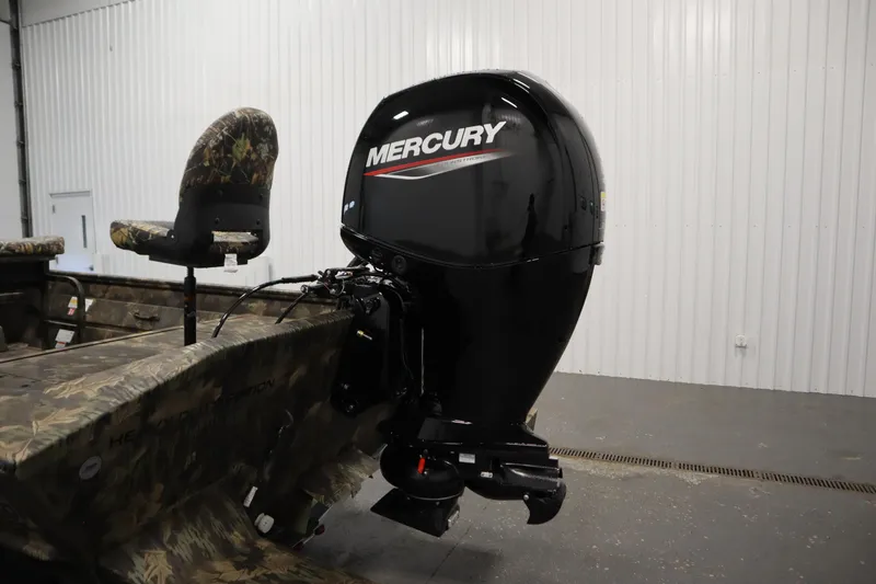 Slide: The Image of 2026 Lowe Roughneck RX2070 CC boat with Mercury outboard motor in a garage. - 29