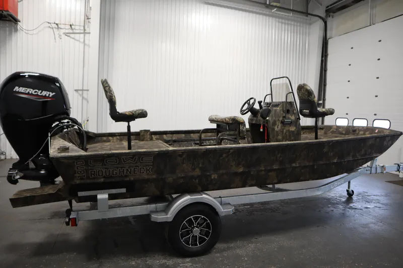 Slide: The Image of 2026 Lowe Roughneck RX2070 CC boat with Mercury engine in a garage setting. - 3