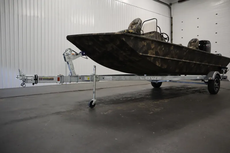 Slide: The Image of 2026 Lowe Roughneck RX2070 CC boat on trailer in indoor storage facility. - 31