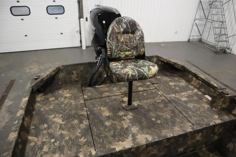 Slide: The Image of 2026 Lowe Roughneck RX2070 CC boat with camo seat and flooring in a garage. - 39