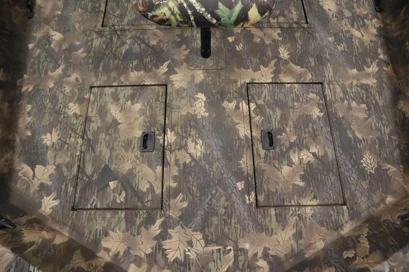 Slide: The Image of 2026 Lowe Roughneck RX1860 Pathfinder boat deck with camouflage pattern and storage compartments. - 11