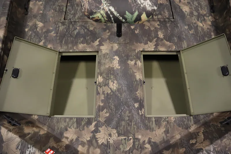 Slide: The Image of 2026 Lowe Roughneck RX1860 Pathfinder boat interior with camo design and open storage compartments. - 12