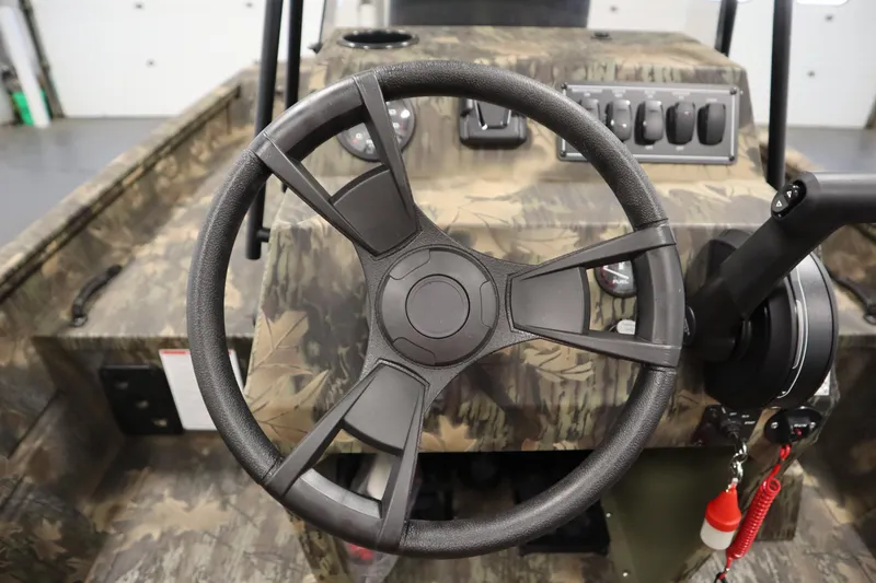 Slide: The Image of 2026 Lowe Roughneck RX1860 Pathfinder steering wheel and control panel in camo design. - 17