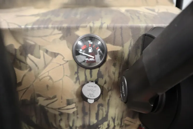 Slide: The Image of Fuel gauge and USB port on 2026 Lowe Roughneck RX1860 Pathfinder boat dashboard. - 19