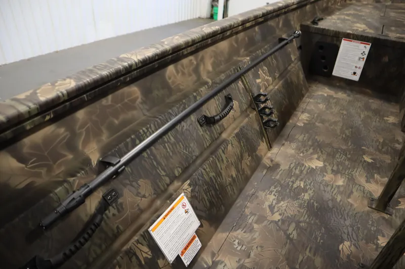 Slide: The Image of 2026 Lowe Roughneck RX1860 Pathfinder interior with camouflage design and mounted accessories. - 23