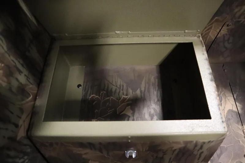 Slide: The Image of Open storage compartment in 2026 Lowe Roughneck RX1860 Pathfinder boat, featuring camouflage interior. - 25